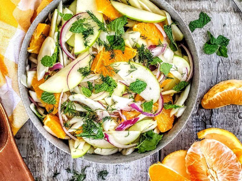 Charmaine Broughton Blog - Mother's Day Brunch Recipes - Fennel Apple and Orange Slaw - image of recipe in rustic bowl surrounded by oranges